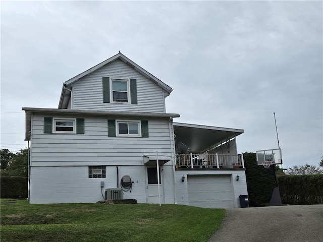 view of property with a garage, central AC unit, and a front yard