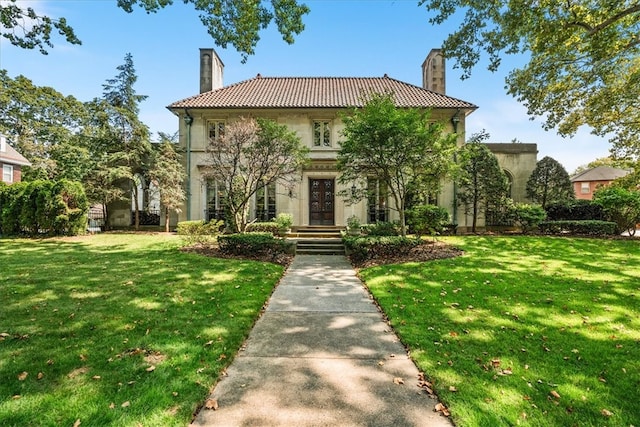 mediterranean / spanish house with a front yard