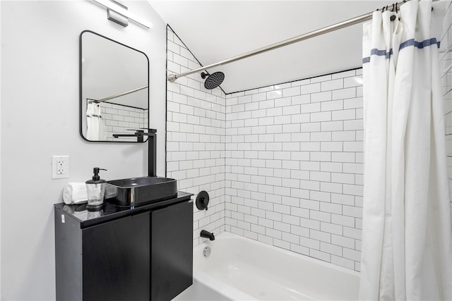 bathroom with vanity, vaulted ceiling, and shower / bath combo