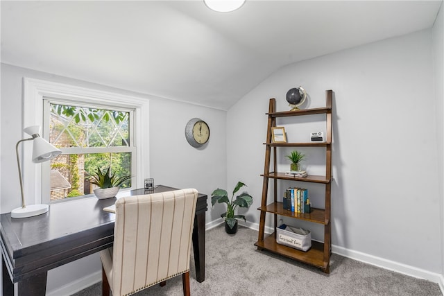 carpeted dining room featuring lofted ceiling