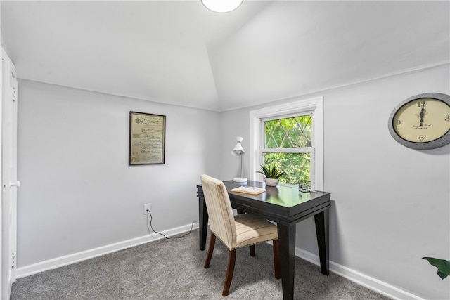 carpeted home office featuring lofted ceiling