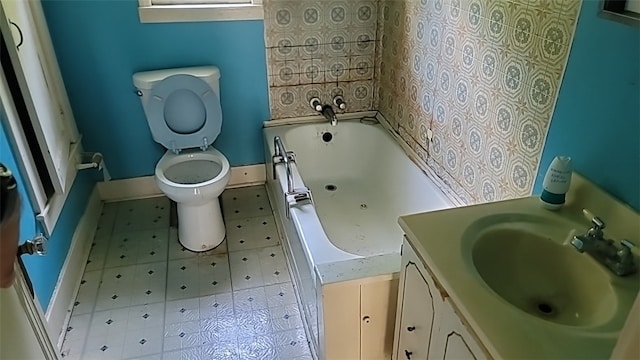 bathroom featuring vanity, toilet, and a bathing tub