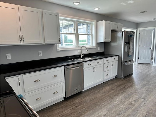 kitchen featuring dark wood-type flooring, white cabinetry, sink, and stainless steel appliances