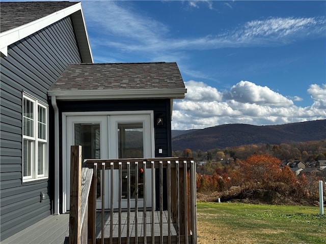 exterior space with a lawn and a deck with mountain view