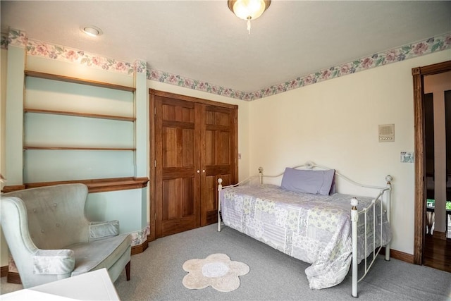 bedroom with baseboards and carpet flooring