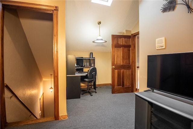 home office featuring baseboards, carpet, and lofted ceiling with skylight