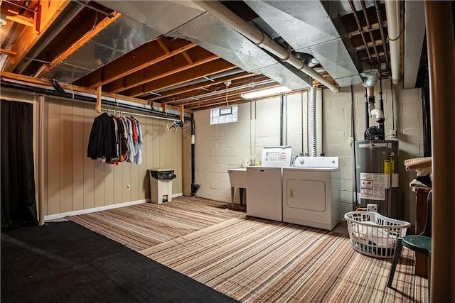 basement with gas water heater and washing machine and clothes dryer