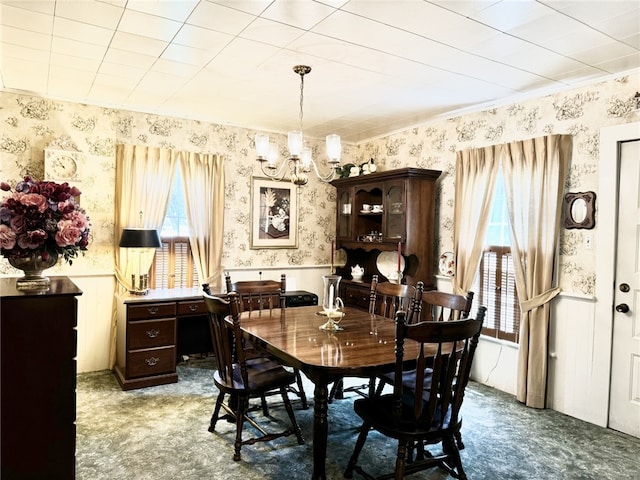 dining room with a chandelier and carpet floors