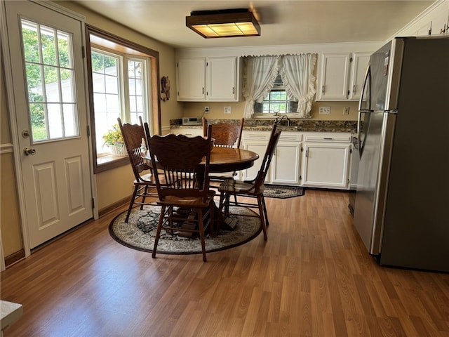 dining room featuring sink and hardwood / wood-style flooring