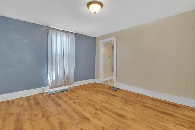 unfurnished room featuring hardwood / wood-style floors