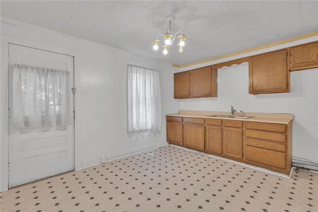 kitchen featuring hanging light fixtures, sink, and an inviting chandelier