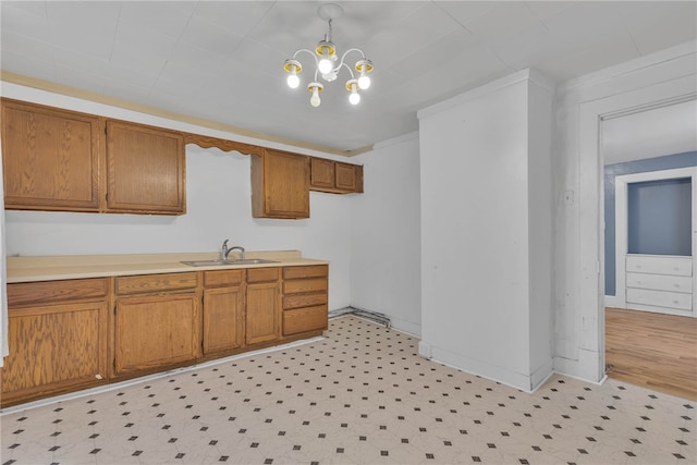 kitchen with hanging light fixtures, an inviting chandelier, and sink