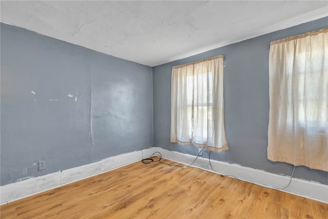 spare room featuring wood-type flooring