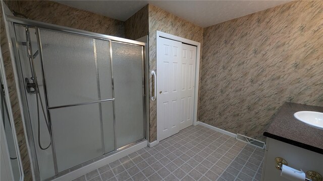 bathroom featuring walk in shower and vanity