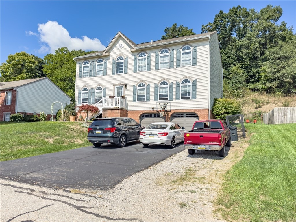 view of front of home with a garage and a front lawn