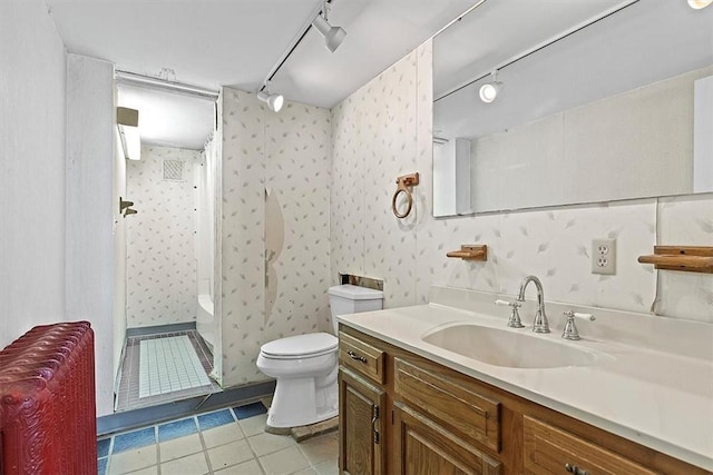 bathroom with vanity, tile patterned flooring, rail lighting, and toilet