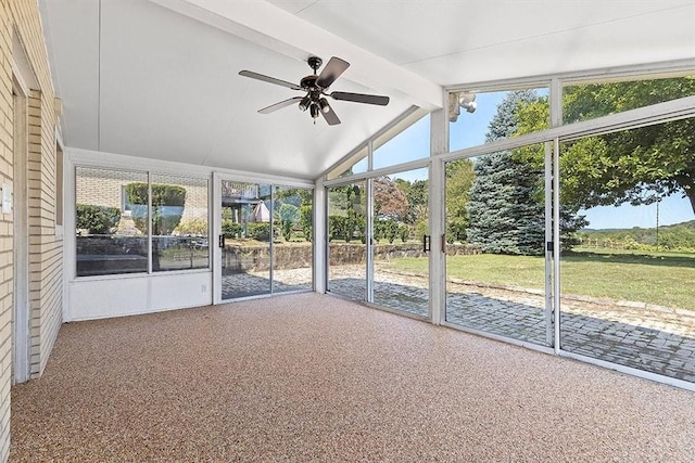 unfurnished sunroom featuring lofted ceiling with beams