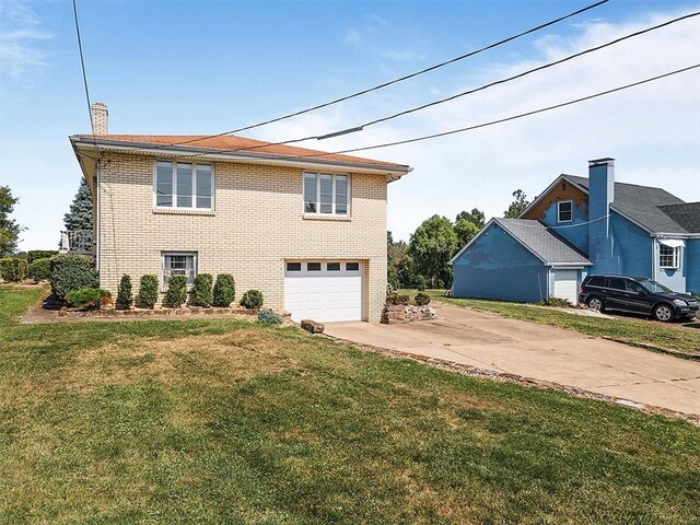 view of front of property with a front lawn and a garage