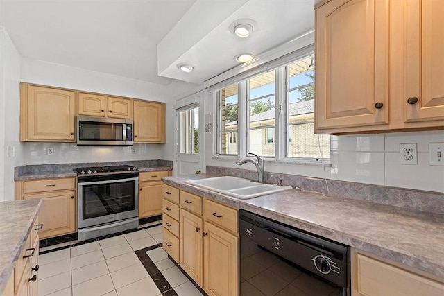 kitchen featuring light brown cabinets, light tile patterned flooring, sink, and appliances with stainless steel finishes