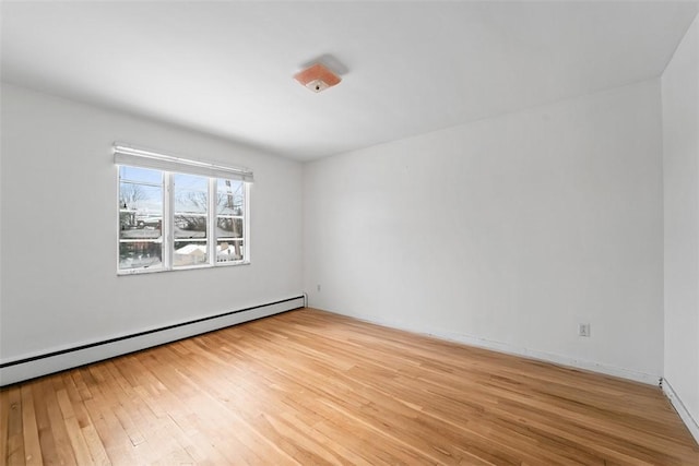 spare room with light hardwood / wood-style flooring and a baseboard radiator