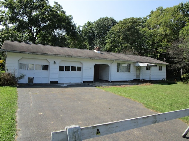 ranch-style home with a garage and a front lawn