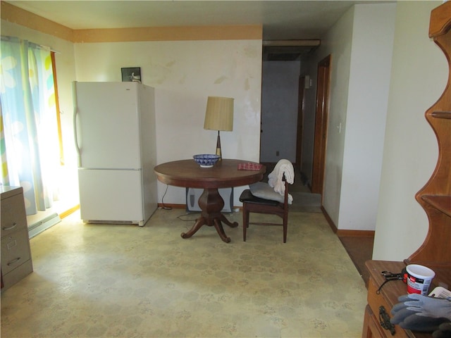 dining space featuring a healthy amount of sunlight and a baseboard radiator