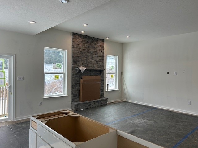 kitchen with white cabinets, plenty of natural light, and a fireplace