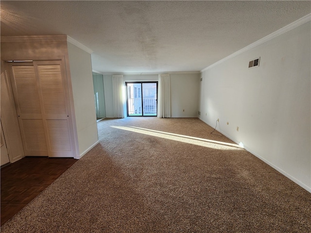 unfurnished room featuring a textured ceiling, ornamental molding, and dark colored carpet