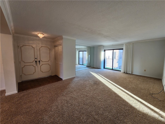 carpeted empty room with ornamental molding and a textured ceiling