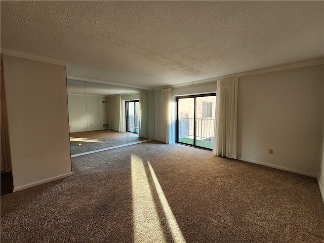 carpeted empty room featuring crown molding and a textured ceiling