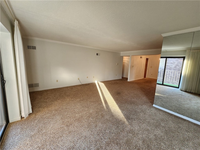 carpeted empty room featuring ornamental molding and a textured ceiling