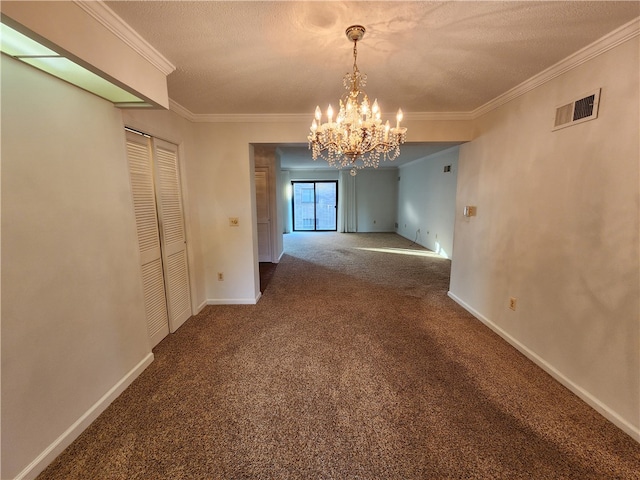 unfurnished dining area with ornamental molding, carpet, a textured ceiling, and a chandelier