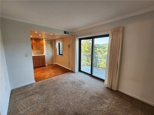 unfurnished living room featuring ornamental molding and wood-type flooring