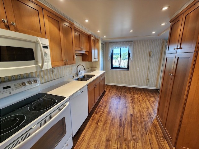 kitchen with white appliances, tasteful backsplash, sink, dark hardwood / wood-style flooring, and crown molding