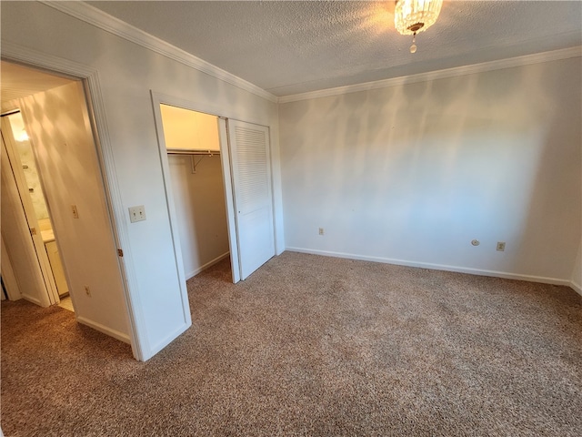 unfurnished bedroom featuring a closet, crown molding, carpet, and a textured ceiling