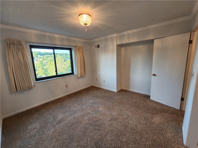 unfurnished bedroom with ornamental molding, a closet, a textured ceiling, and carpet