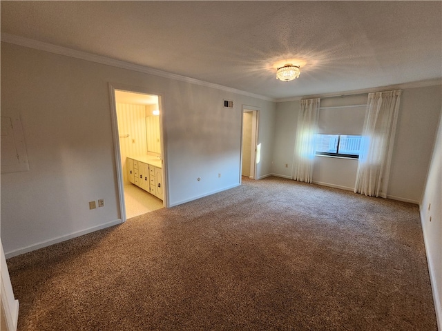 unfurnished bedroom featuring crown molding, a textured ceiling, light colored carpet, and connected bathroom