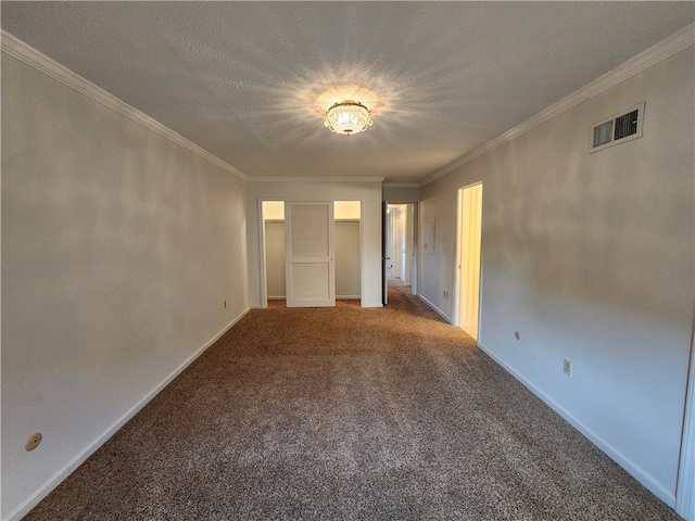 empty room featuring ornamental molding, a textured ceiling, and carpet flooring