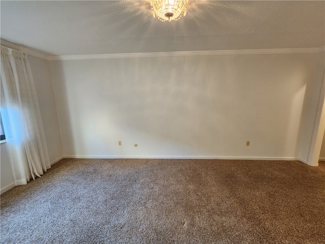 carpeted empty room with ornamental molding and a textured ceiling