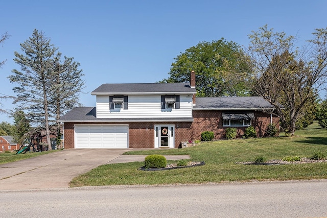 view of front of house with a garage and a front lawn