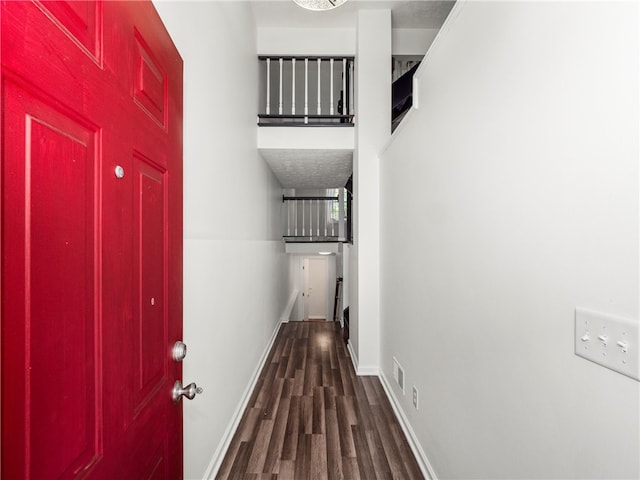 hallway with dark hardwood / wood-style floors