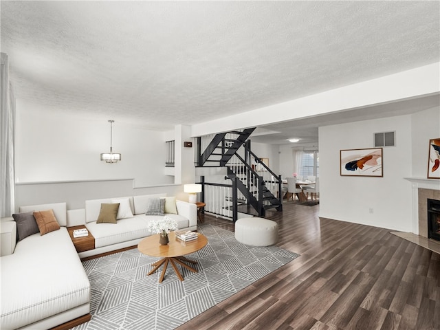 living room featuring hardwood / wood-style floors and a textured ceiling