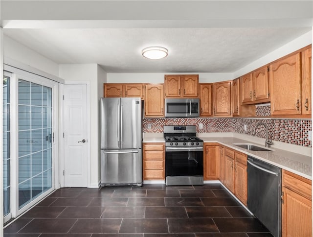 kitchen featuring backsplash, appliances with stainless steel finishes, and sink