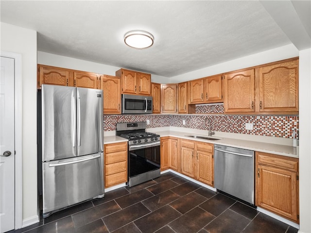 kitchen featuring tasteful backsplash, stainless steel appliances, and sink