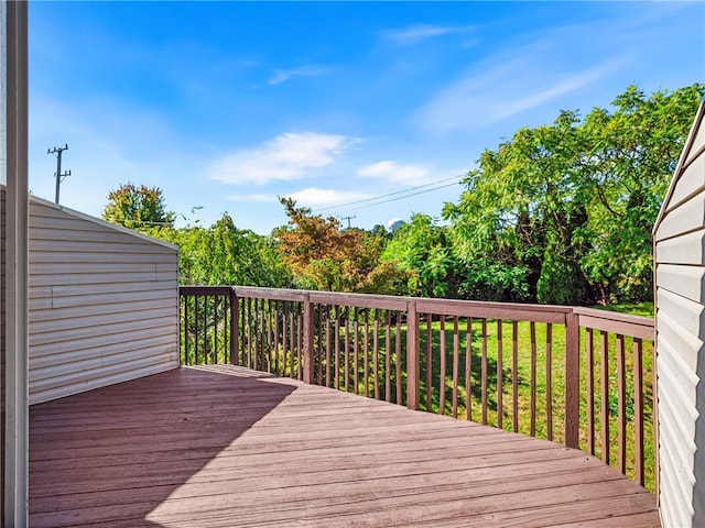 wooden terrace with a lawn