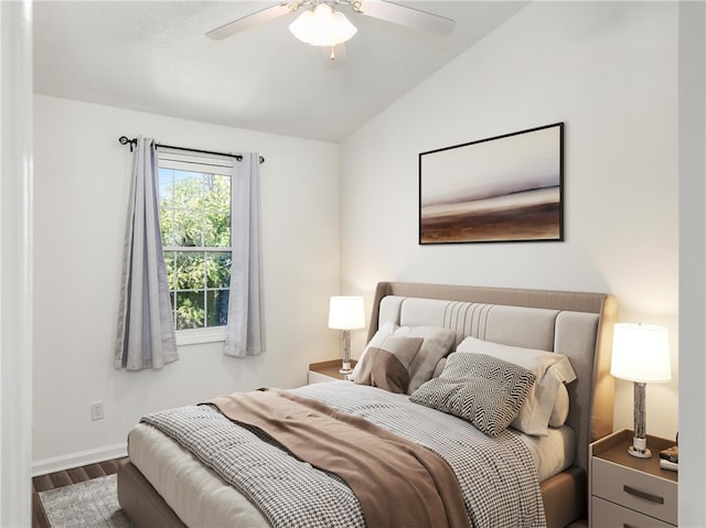 bedroom featuring ceiling fan, hardwood / wood-style flooring, and lofted ceiling