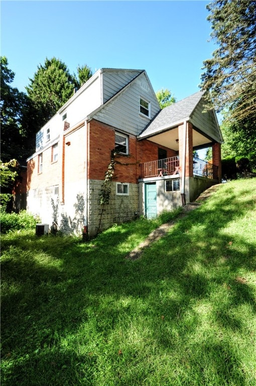 rear view of house with a lawn