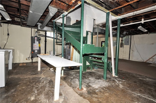 basement featuring water heater, electric panel, and washing machine and dryer