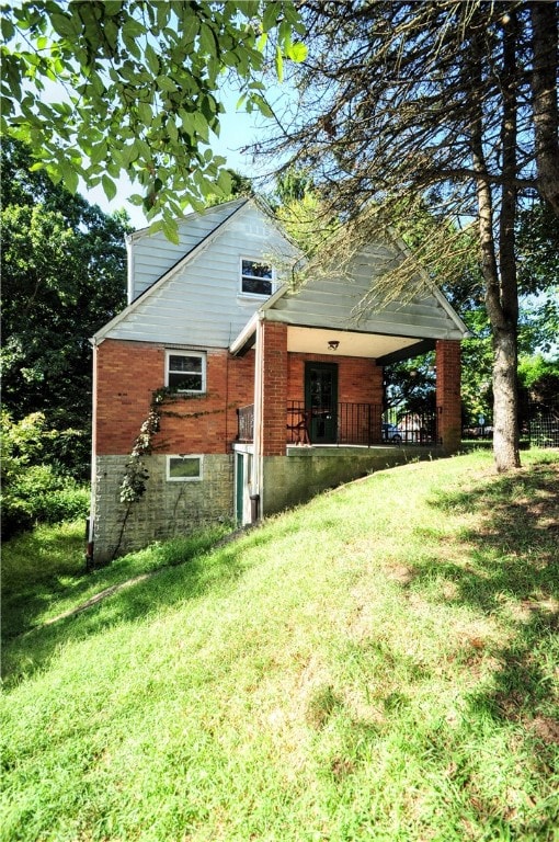 rear view of house featuring a yard