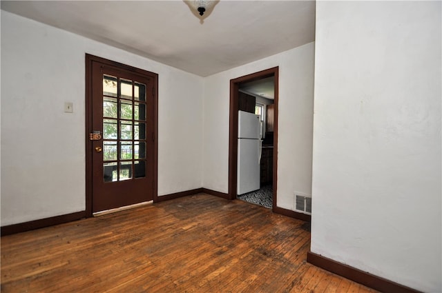 unfurnished room with dark hardwood / wood-style floors